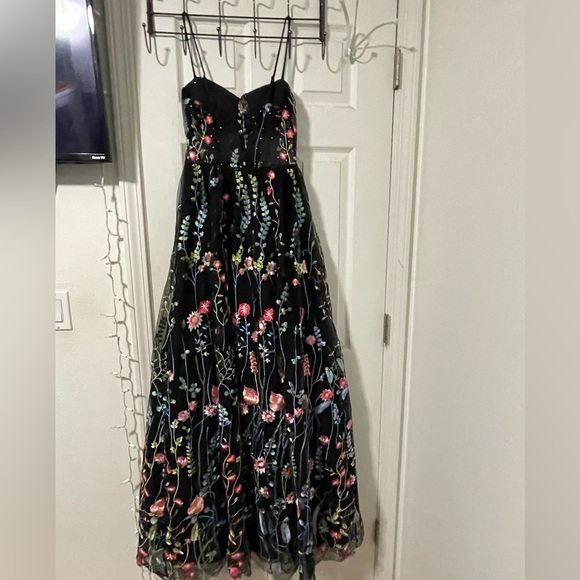 It is black, with flowers and rhinestones. - Picture 3 of 3